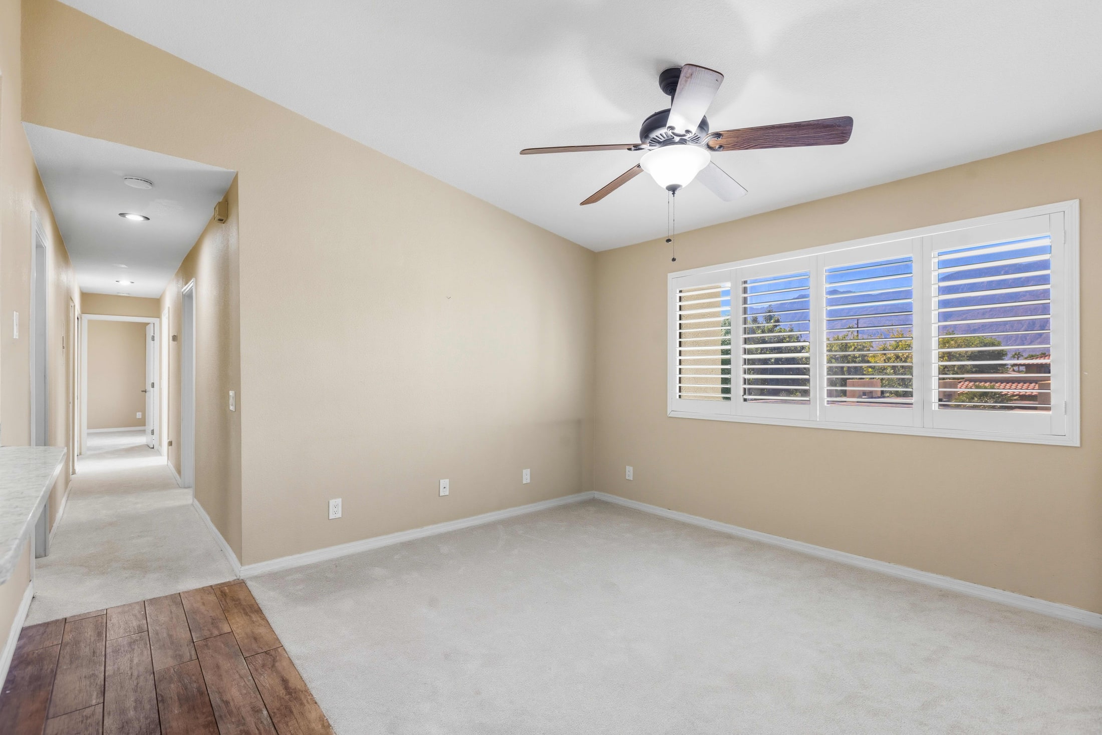The same bonus room before staging, with nothing in the frame to measure the space against.
