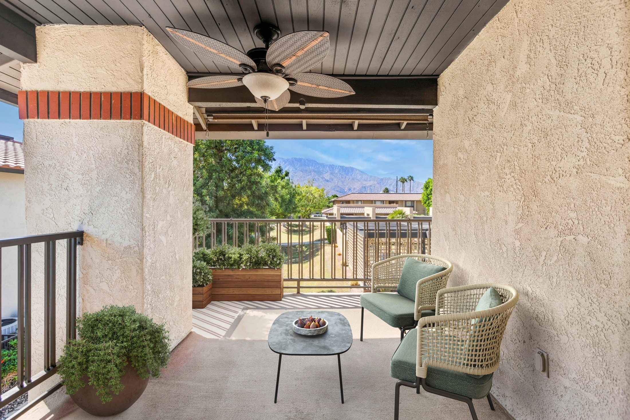 A covered balcony reads as living space once there is somewhere to sit in it.