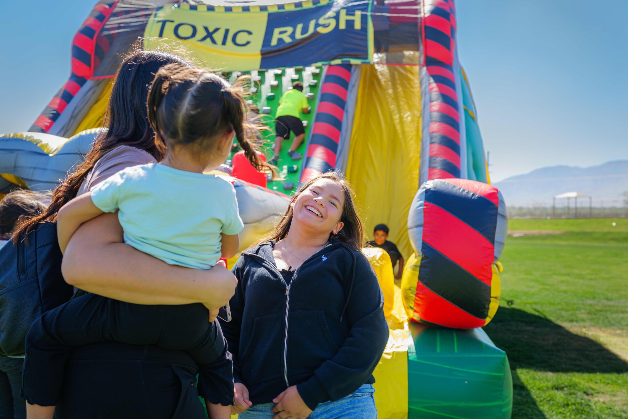 Kids playing on an inflatable slide at a community event
