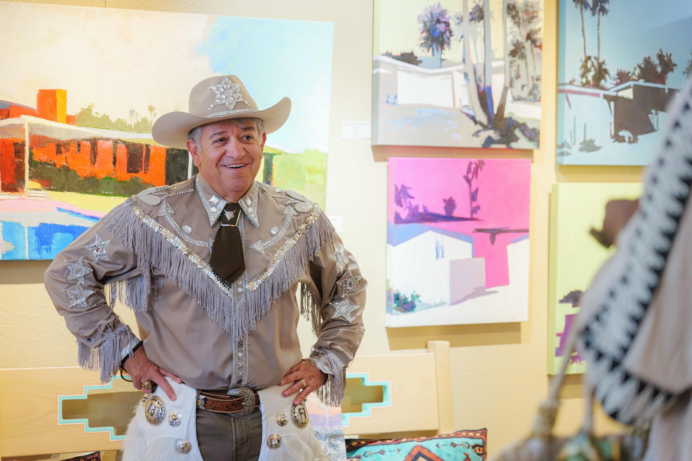 Guest in a rhinestone western outfit at an art gallery event