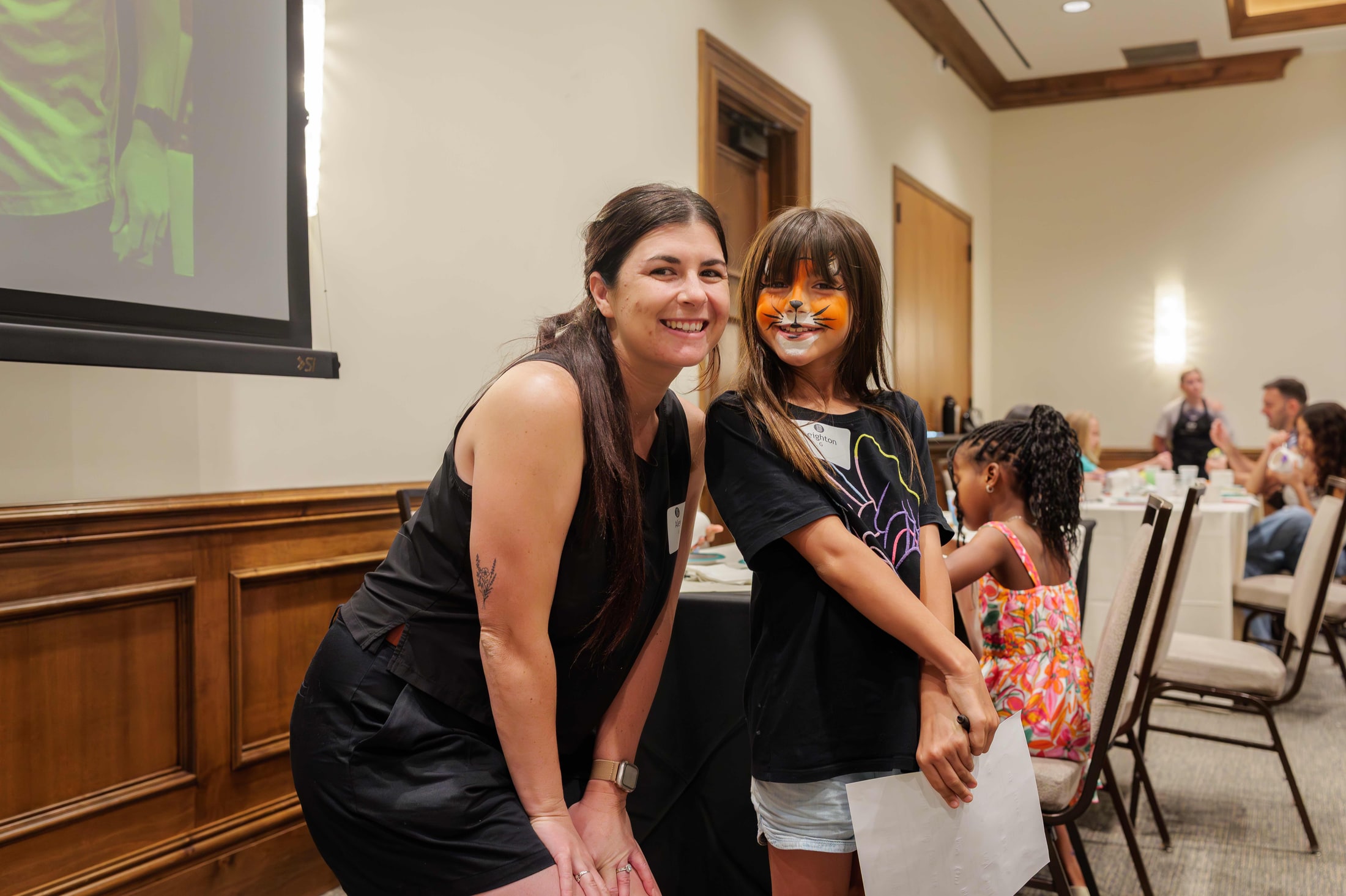 Child getting their face painted at a community event
