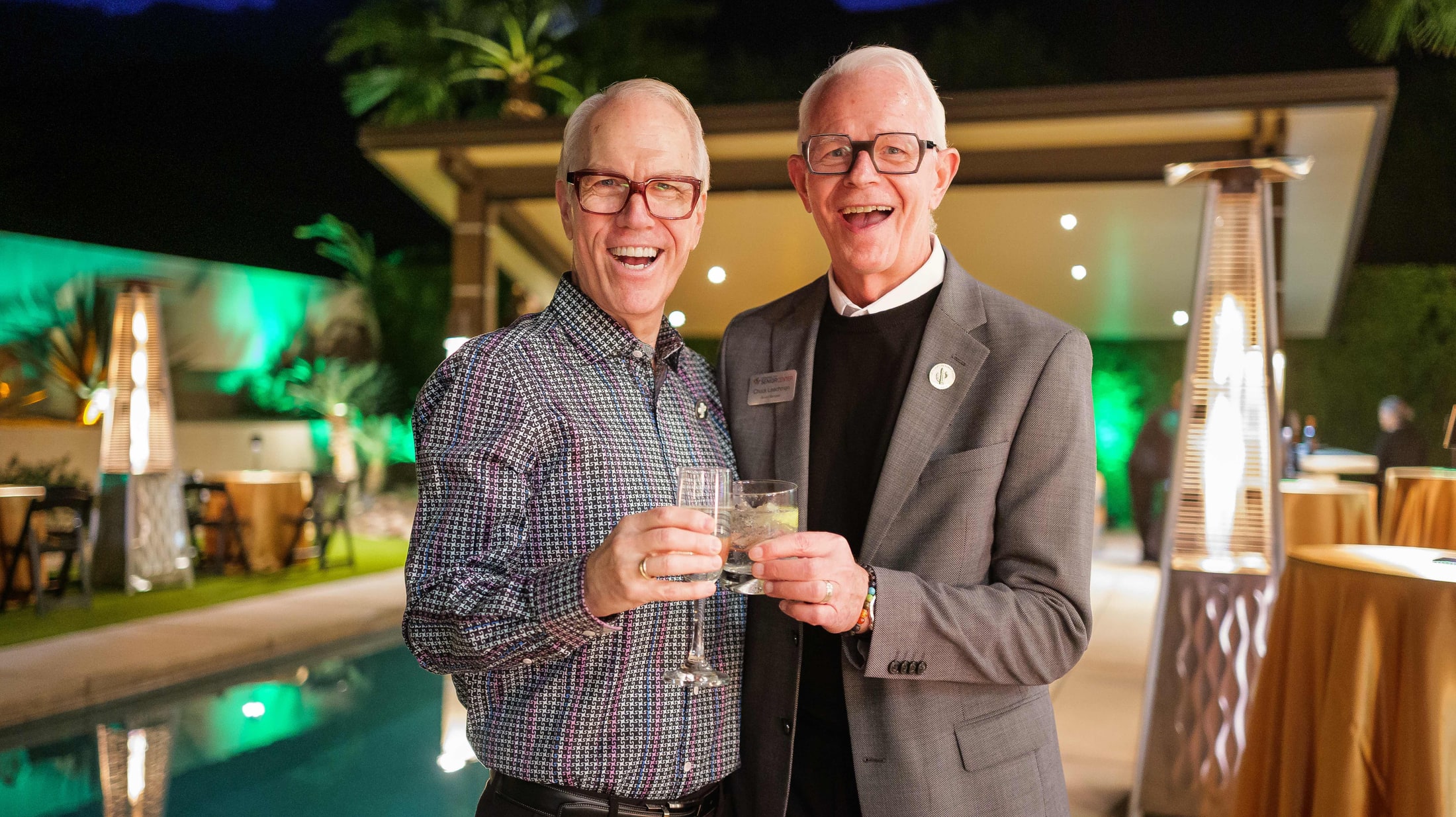 Two guests toasting at an evening event
