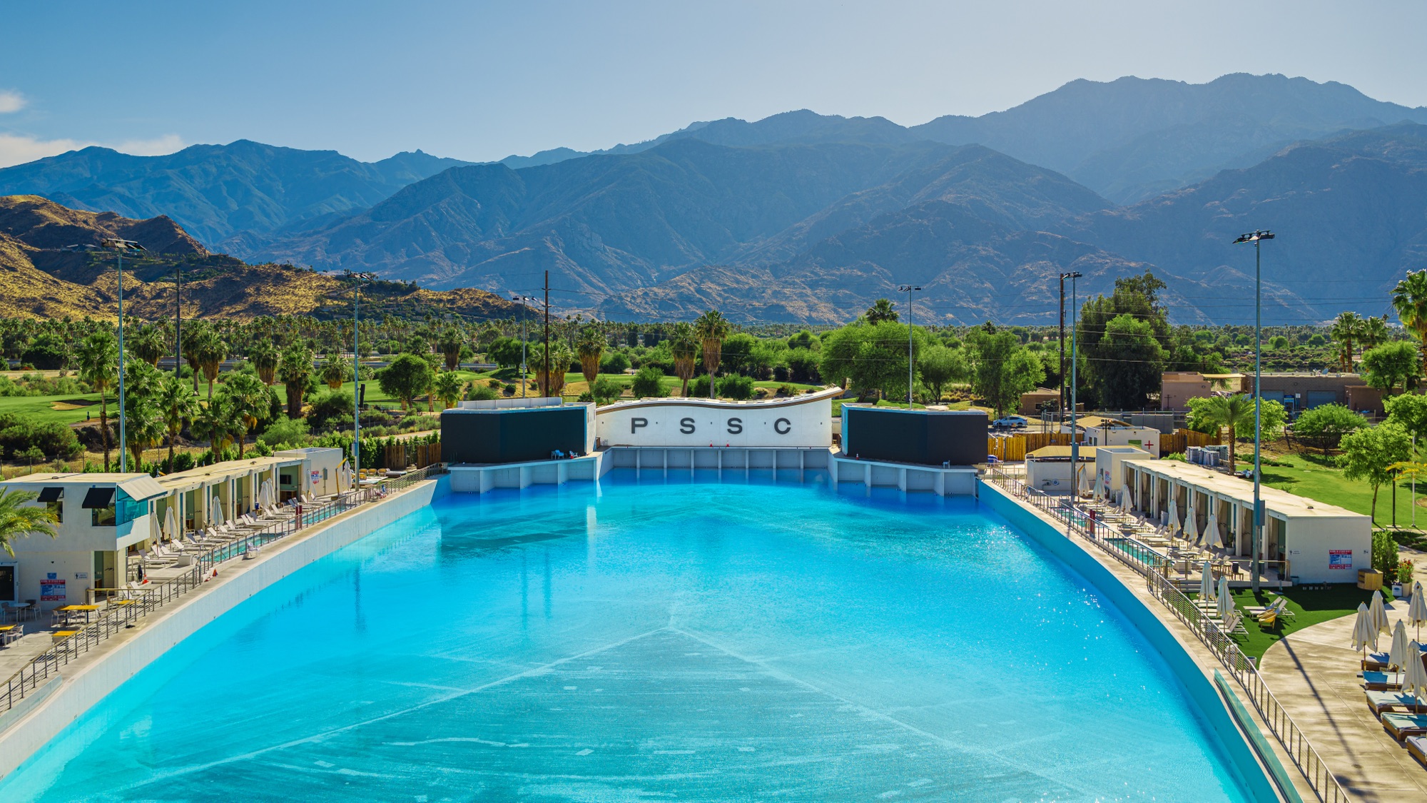 Aerial view of a community pool surrounded by mountains