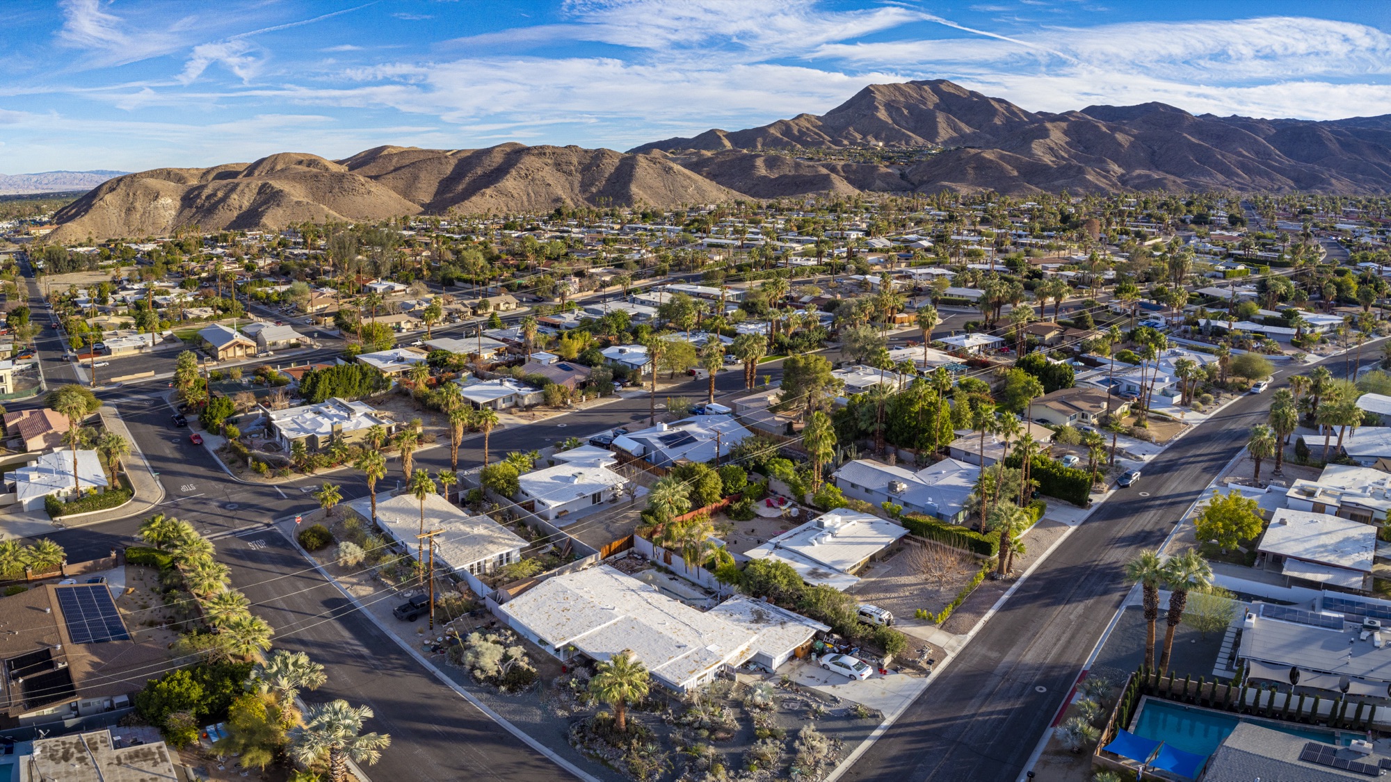 Aerial drone view of a Coachella Valley neighborhood at golden hour
