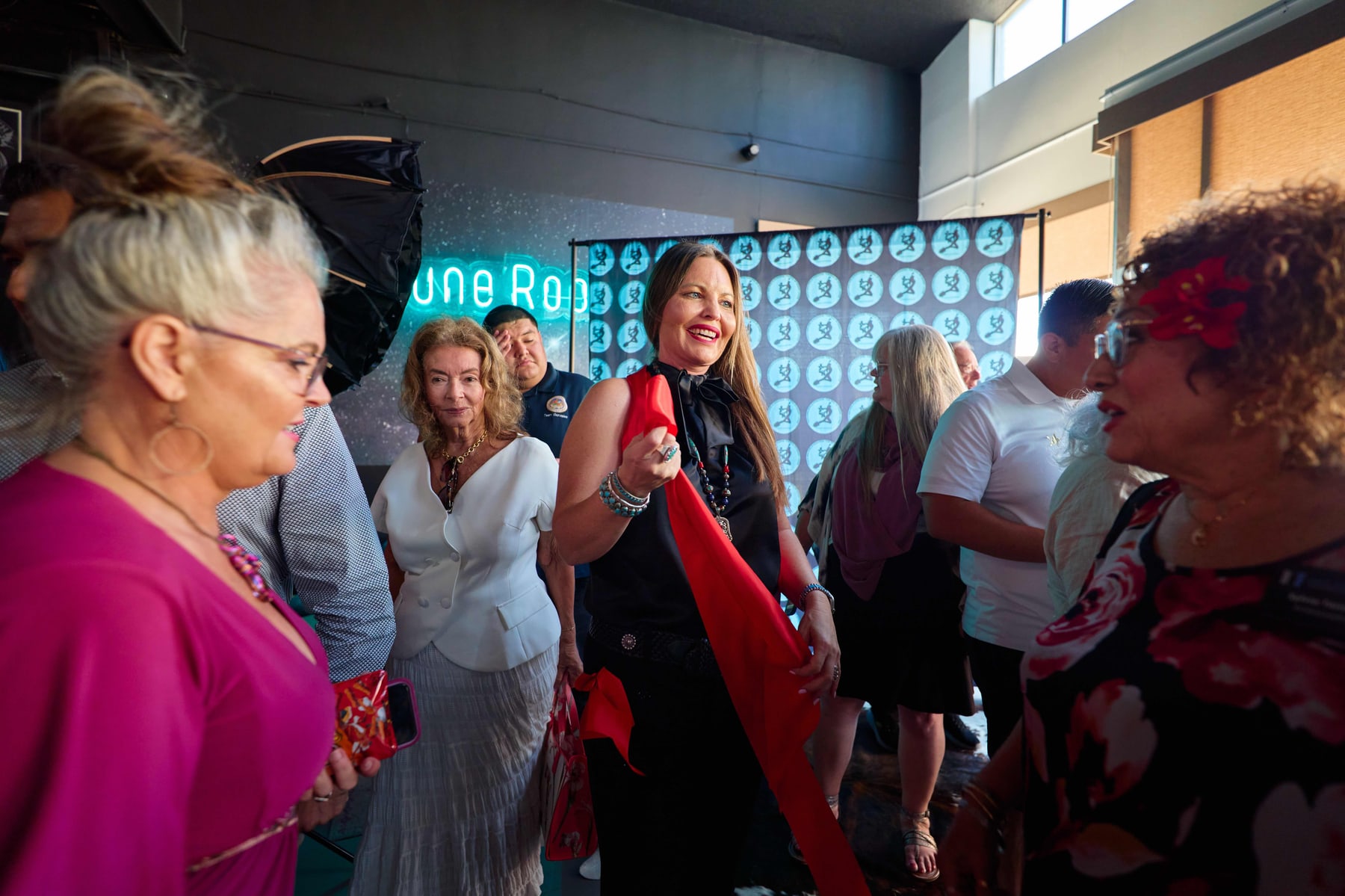 Guests holding the red ribbon at the Yucca Brevifolia launch