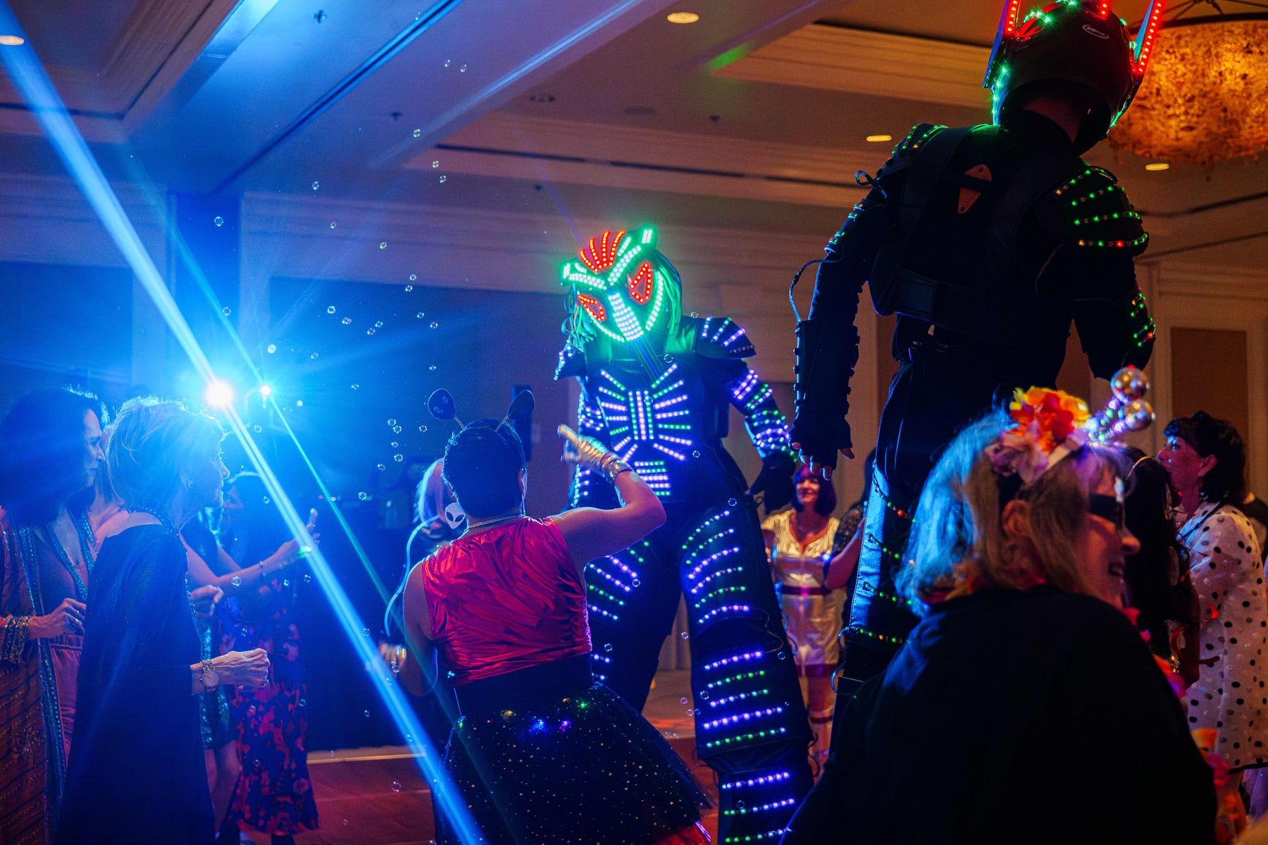 Guests in light up costumes on the floor at the Out of This World Gala