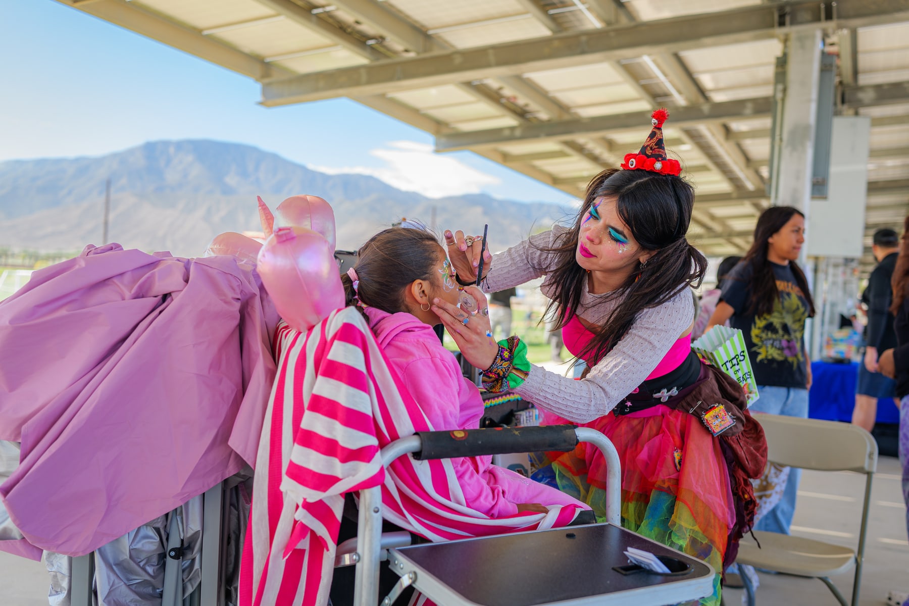 Costumed guests outdoors with the mountains behind them at a Ganas event