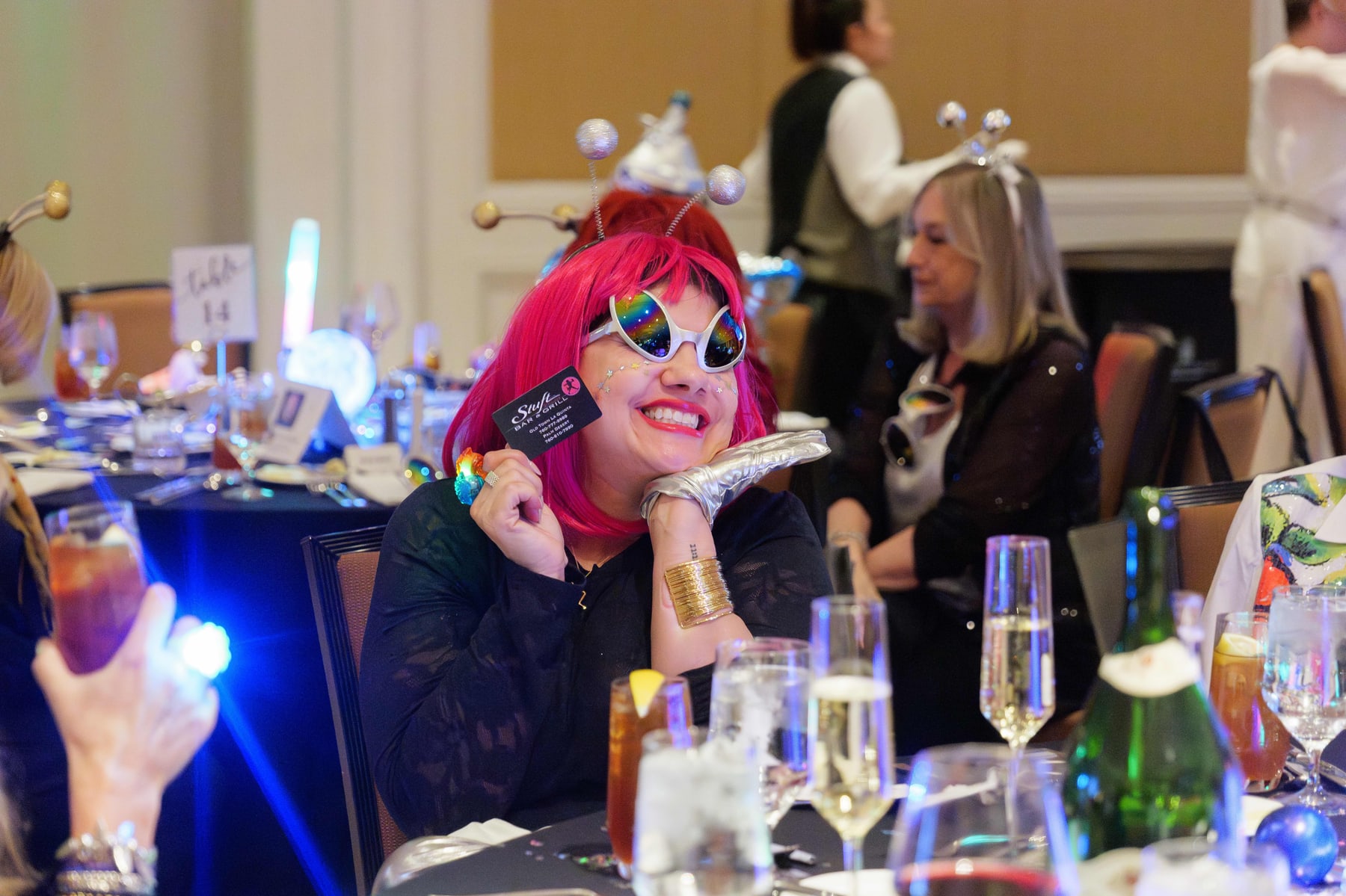 Guests in space themed headpieces at a banquet table