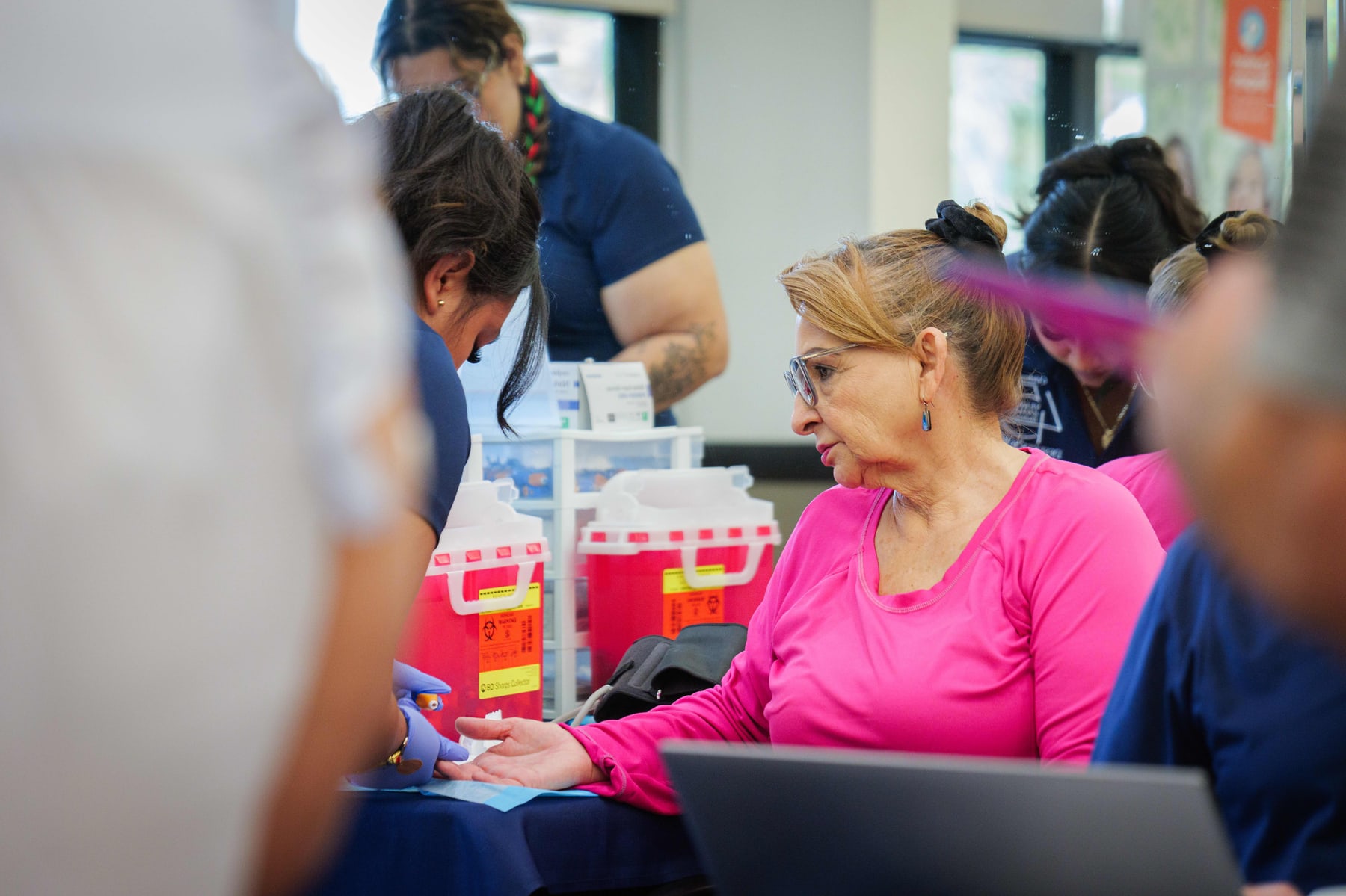 A volunteer at the welcome table at the Indio Senior Center fair
