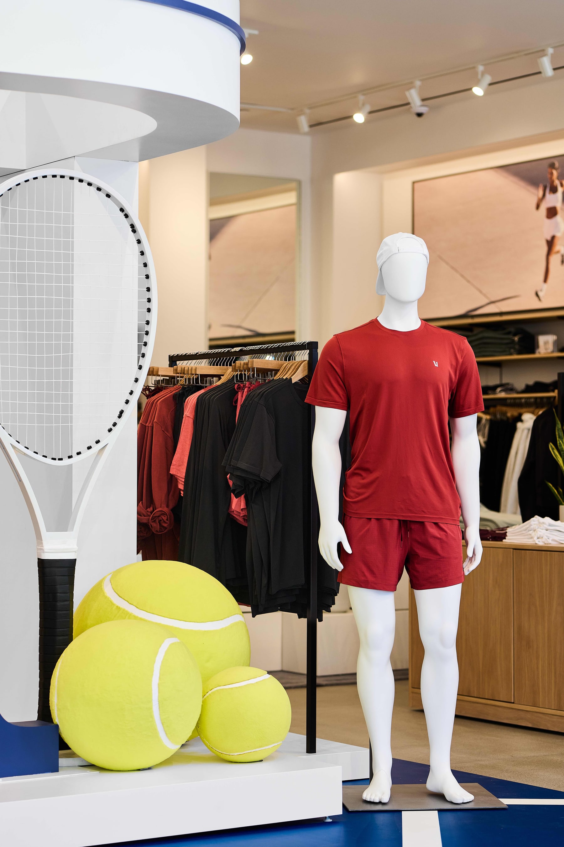 Tennis display with racket and oversized balls inside the store