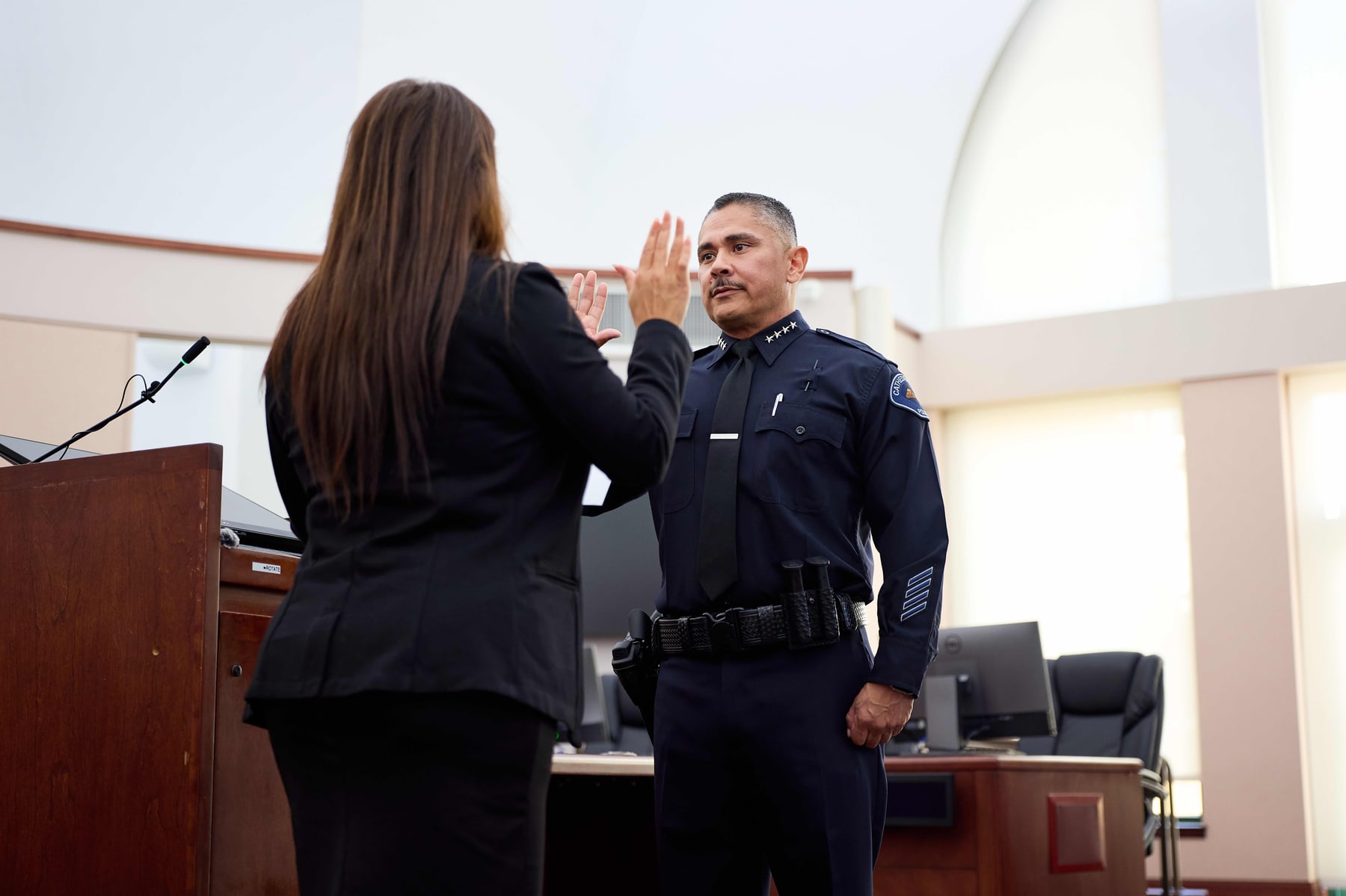 An officer raising his right hand to take the oath