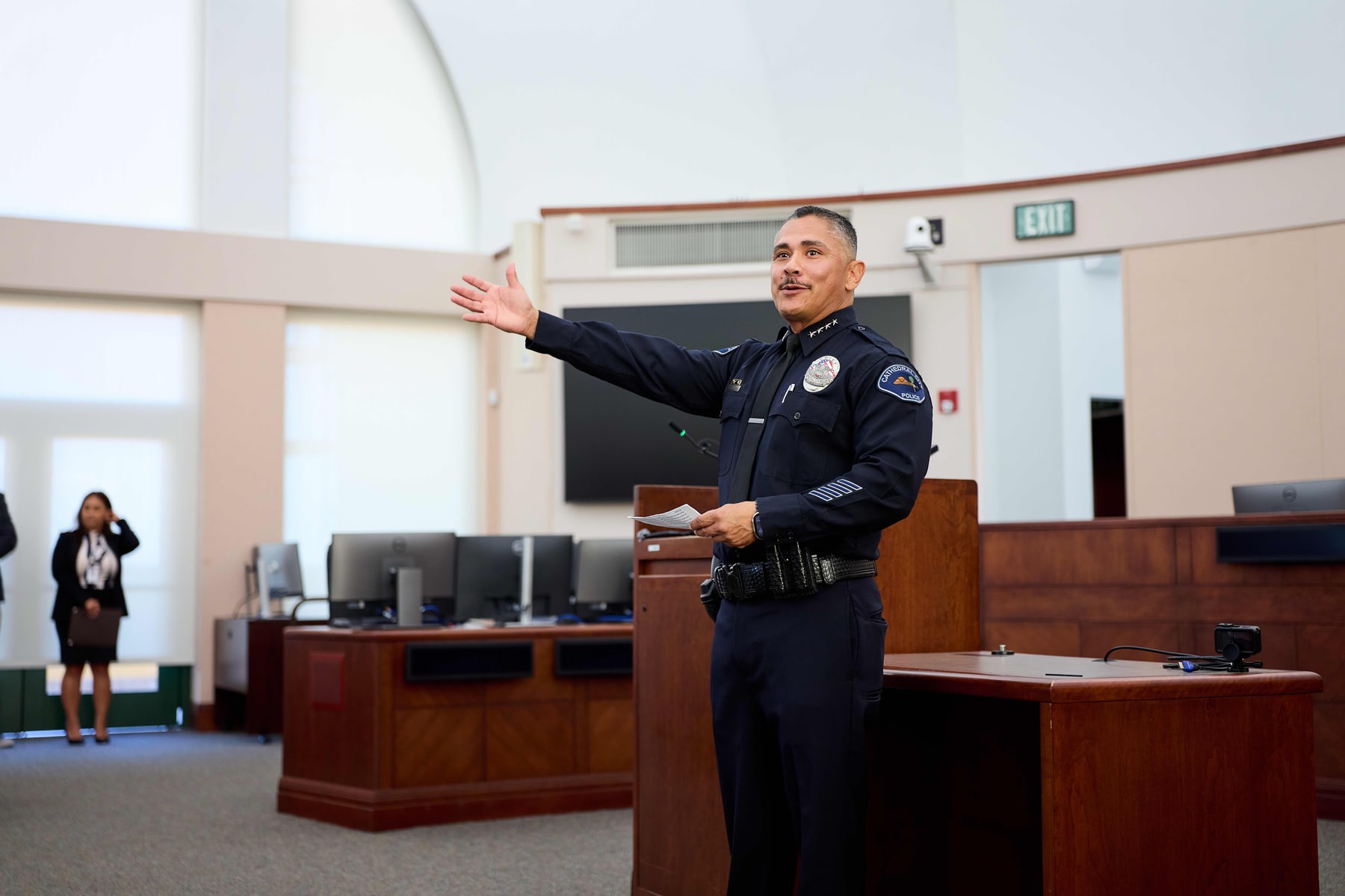 An officer acknowledging the room after taking the oath