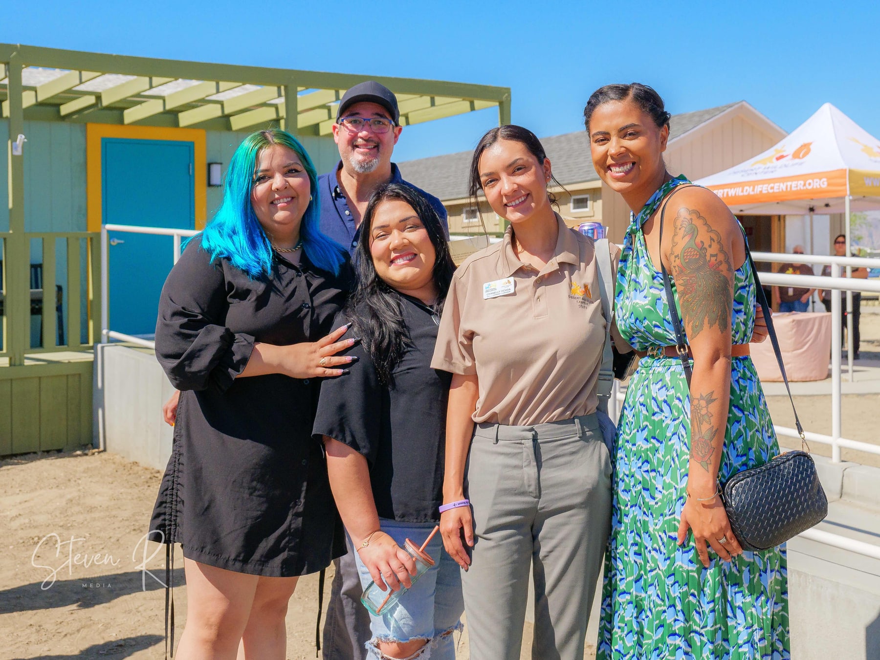 Four people outside the building at the Desert Wildlife opening