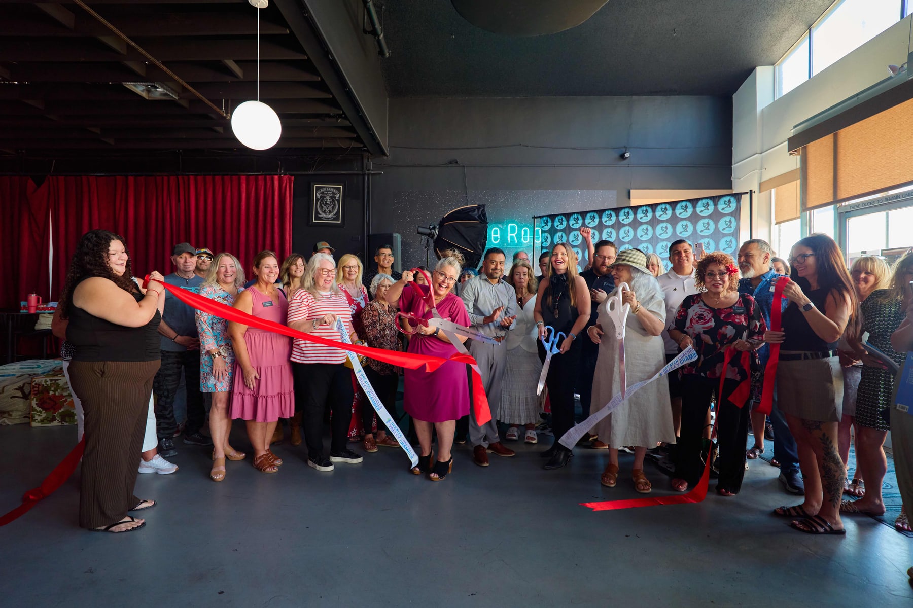 Cutting the red ribbon in front of the crowd at the magazine launch