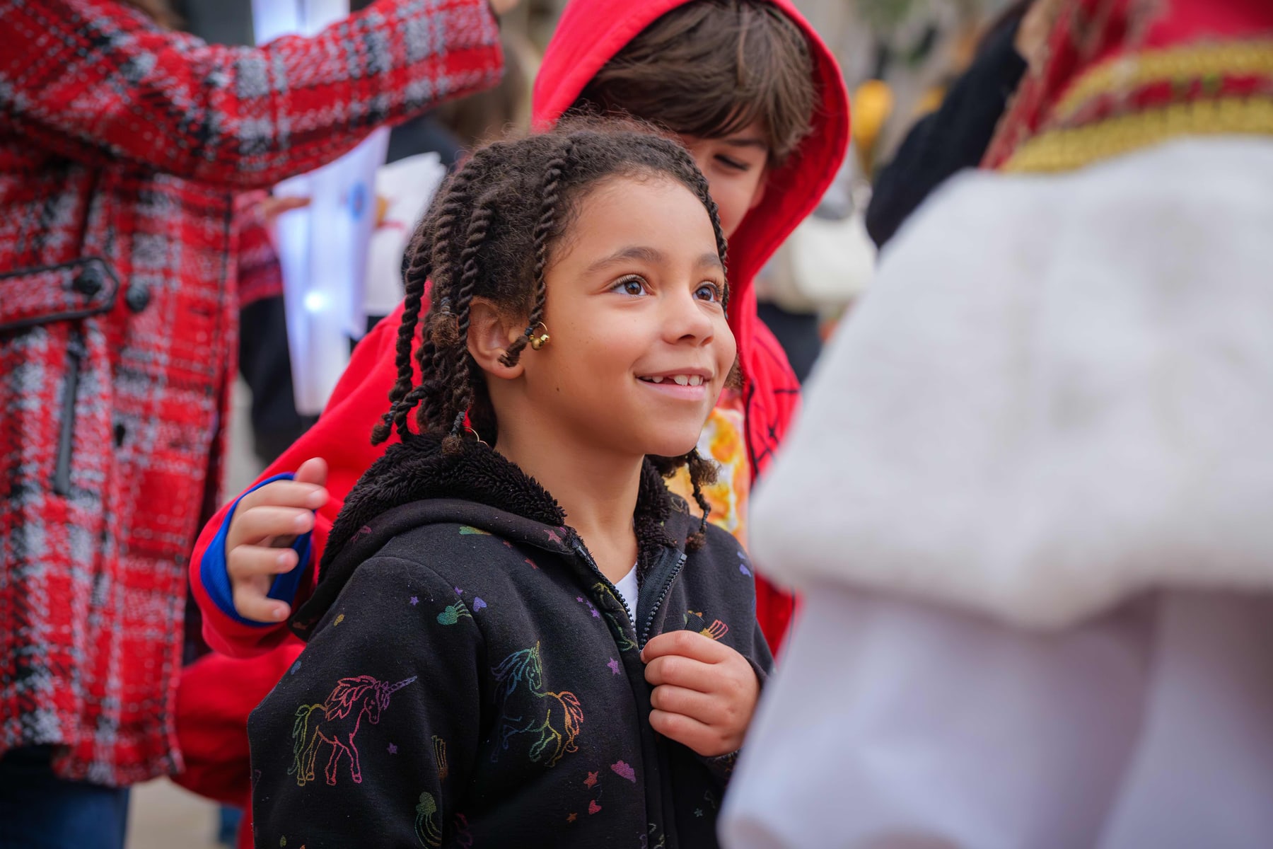 A child in a red coat at the El Paseo tree lighting
