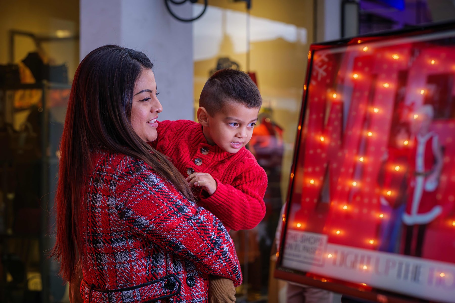 A mother and her son beside the lights on El Paseo