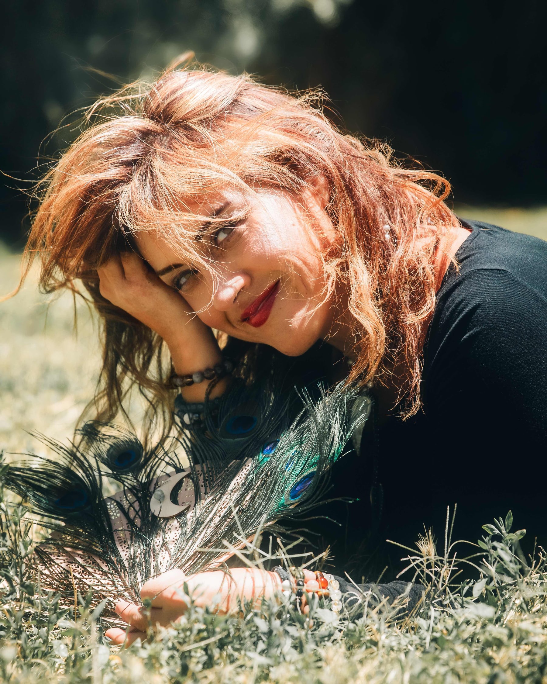 Portrait of a woman lying in golden grass in late light