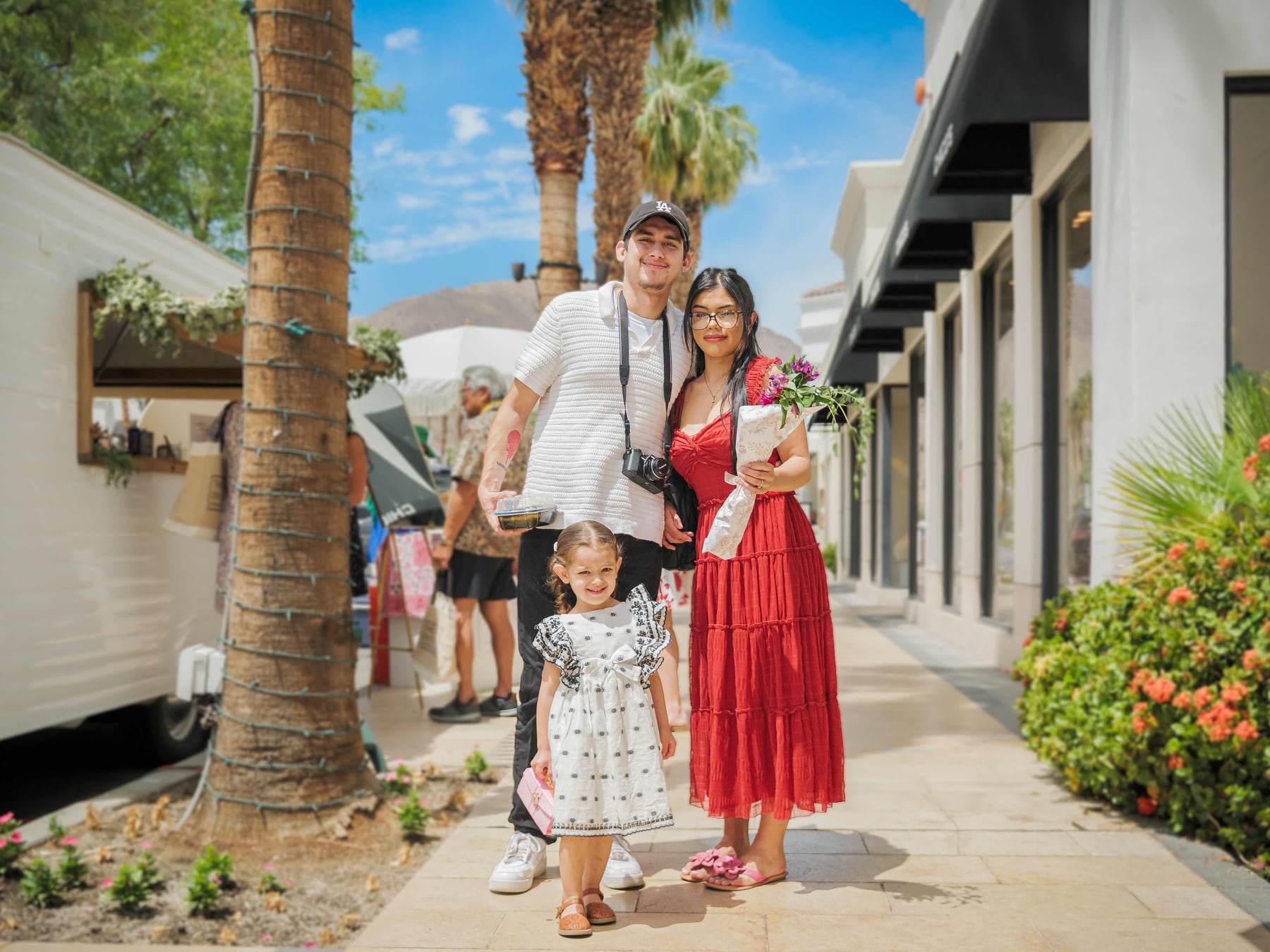A family photographed on the walkway at The Shops on El Paseo