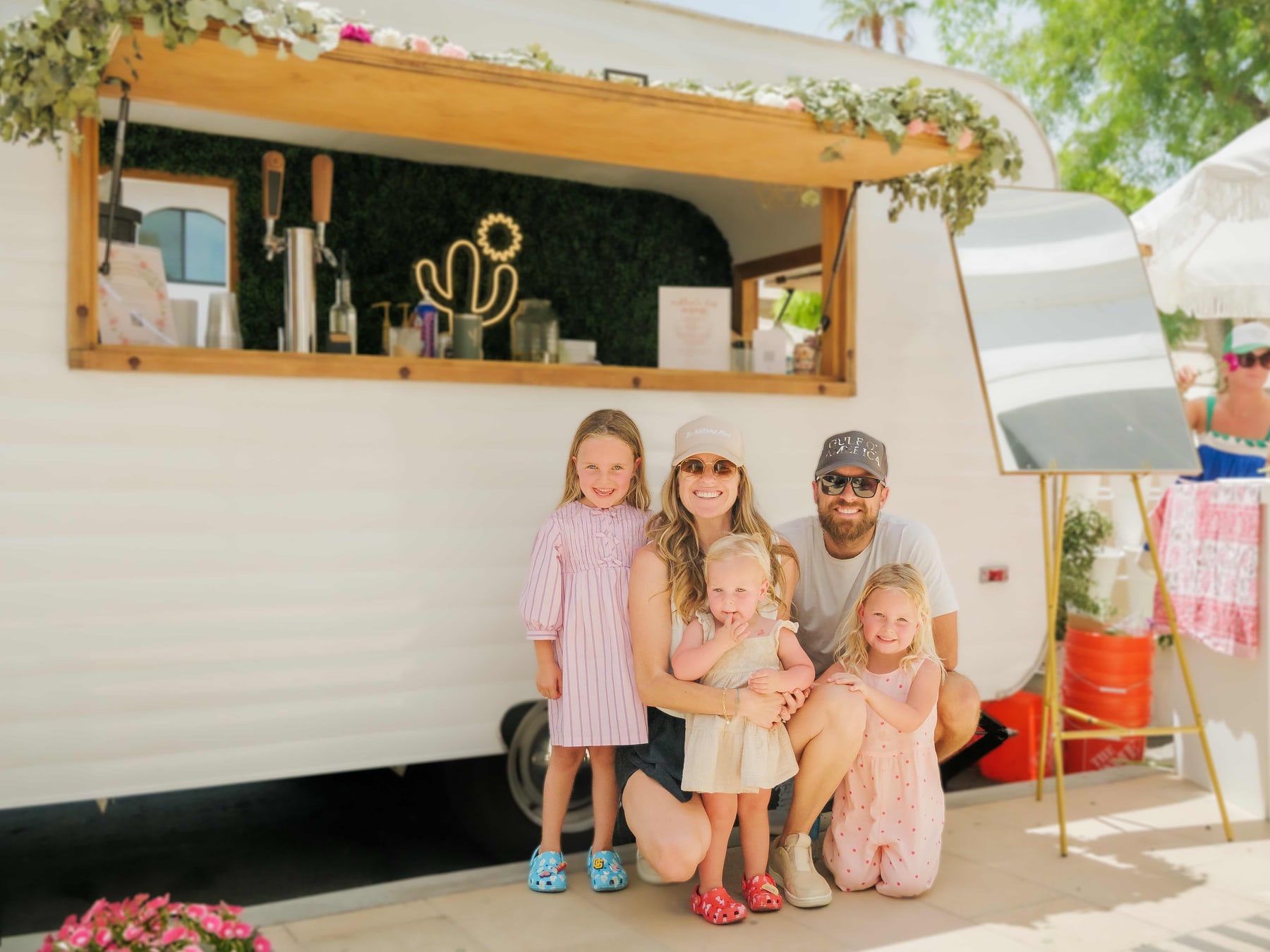 A family beside the vintage trailer bar at The Shops