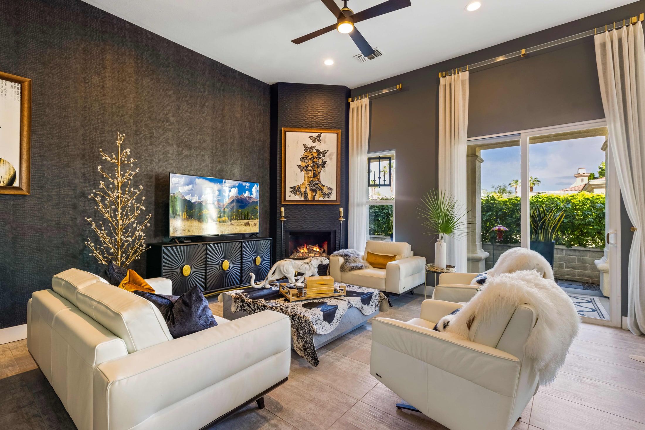 Living room with a dark feature wall, fireplace and mounted television