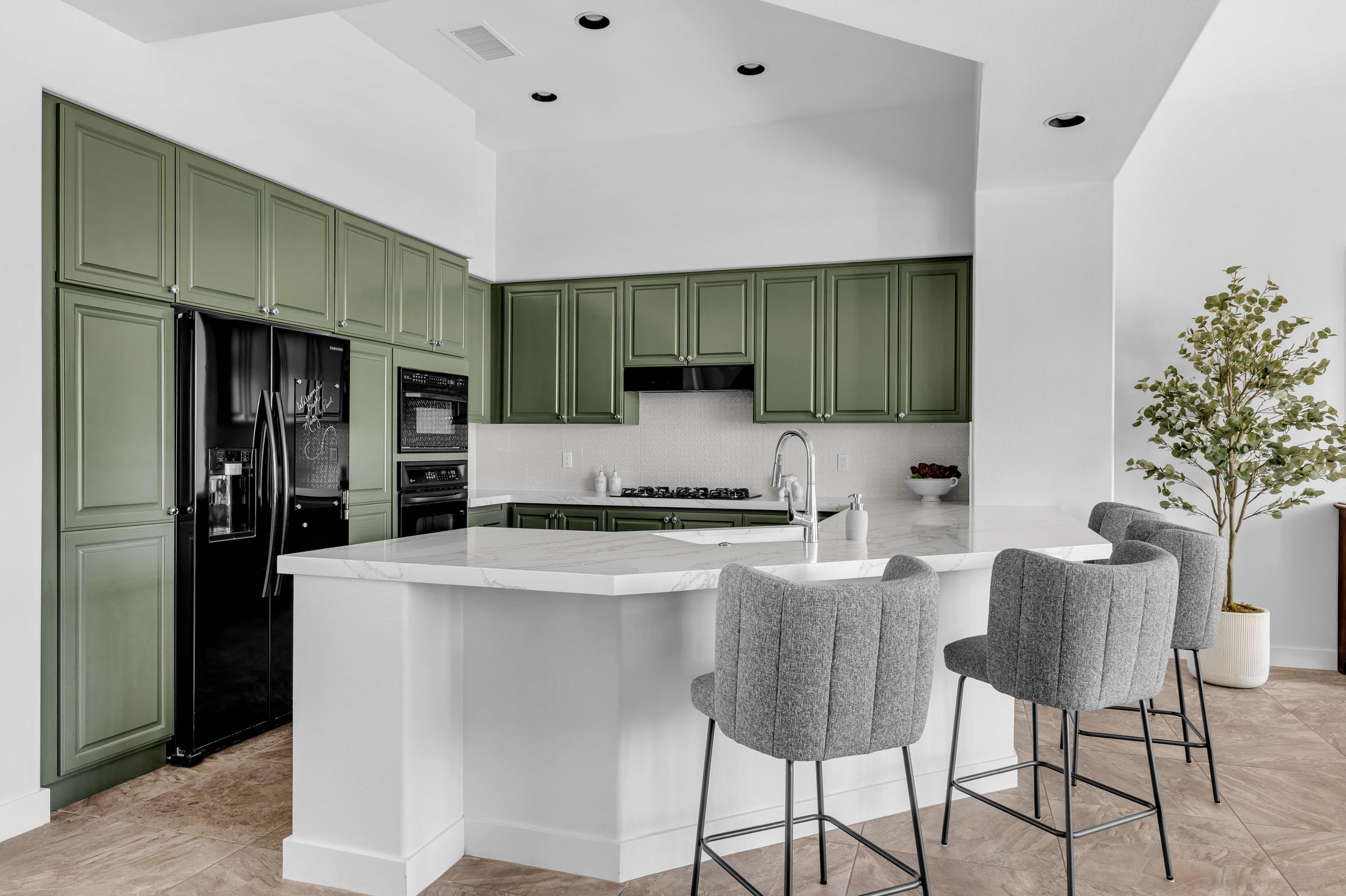 Modern kitchen with sage green cabinets photographed for a listing